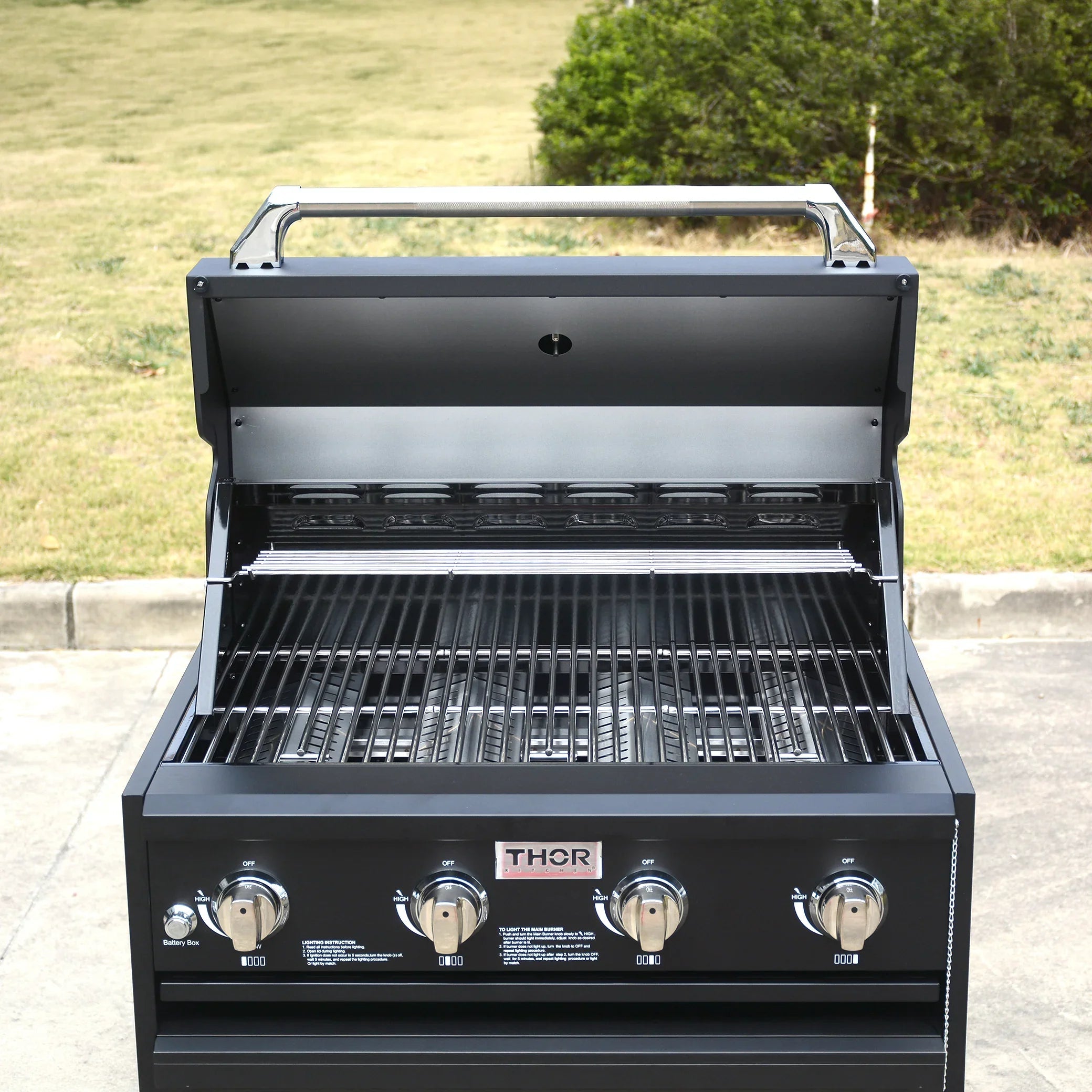Outdoor gas grill with four burners, stainless steel knobs, and open hood on patio